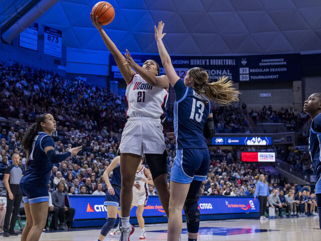 STORRS, CONNECTICUT - JANUARY 15: Sarah Strong #21 of the Connecticut Huskies drives to the rim against Brynn McCurry #13 of the Villanova Wildcats during the second half of an NCAA women's basketball game at Harry A. Gampel Pavilion on January 15, 2026 in Storrs, Connecticut.