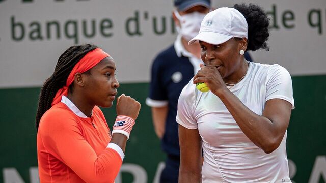 Coco Gauff L and Venus Williams of the United States communicate with each other during their women's doubles first round match against Ellen Perez of Australia and Zheng Saisai of China at the French Open tennis tournament at Roland Garros in Paris, France, June 2, 2021.