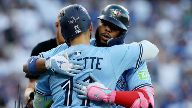 Los Angeles, CA, October, 29, 2025: Toronto Blue Jays first baseman Vladimir Guerrero Jr. (27) is congratulated by Toronto Blue Jays' Bo Bichette (11) after hitting a solo home run during first the inning of Game five of the World Series between the Los Angeles Dodgers and the Toronto Blue Jays at Dodger Stadium on Wednesday, October 29, 2025 in Los Angeles, CA. (Robert Gauthier/Los Angeles Times via Getty Images)