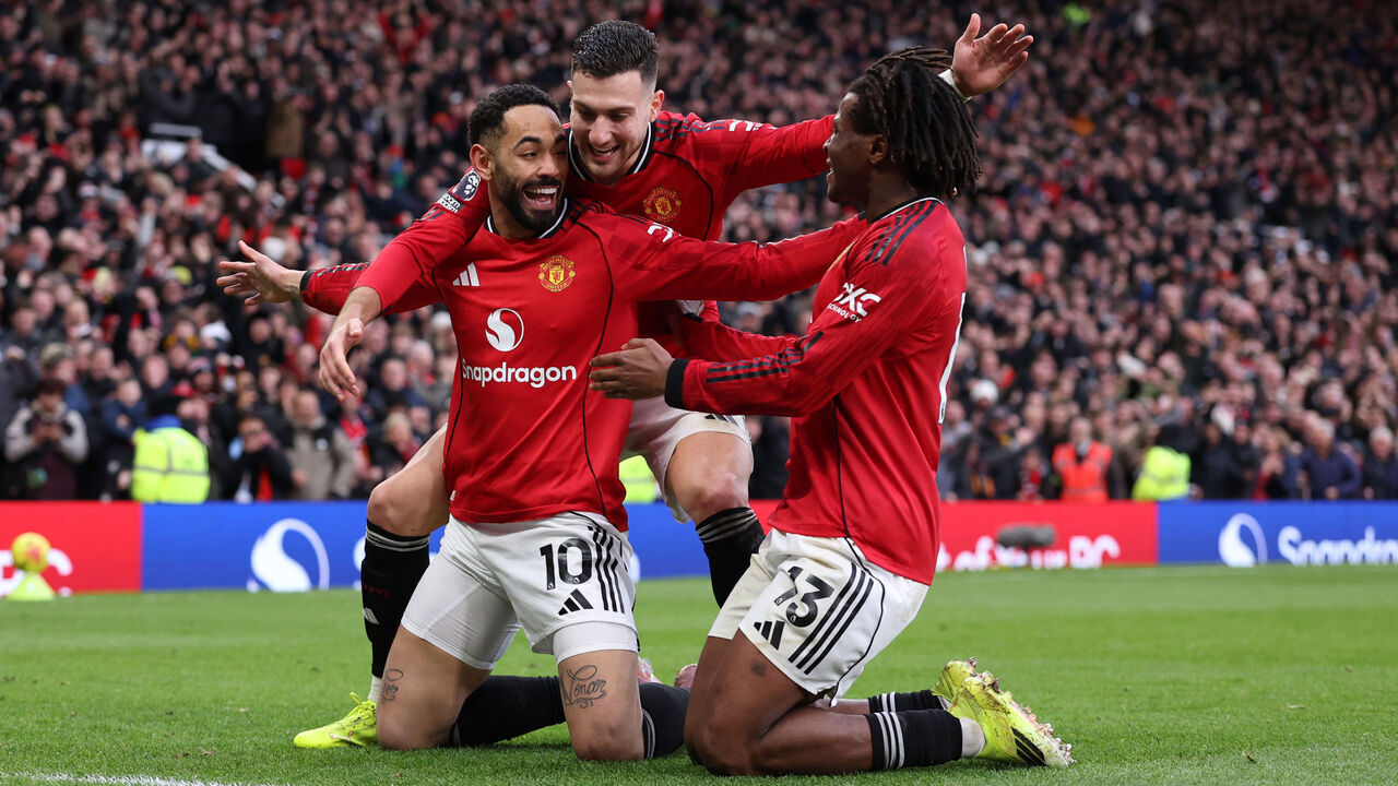 MANCHESTER, ENGLAND - JANUARY 17: Patrick Dorgu of Manchester United celebrates after he scores a goal to make it 2-0 with Matheus Cunha and Diogo Dalot of Manchester United during the Premier League match between Manchester United and Manchester City at Old Trafford on January 17, 2026 in Manchester, England.