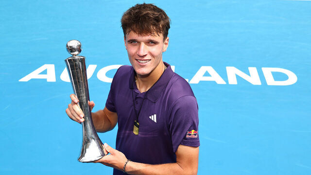 AUCKLAND, NEW ZEALAND - JANUARY 17: Jakub Mensik of Czech Republic with the trophy after victory in the singles final defeating Sebastian Baez of Argentina during day 13 of the 2026 ASB Classic at ASB Tennis Centre on January 17, 2026 in Auckland, New Zealand.