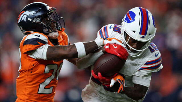 DENVER, COLORADO - JANUARY 17: Ja'quan McMillian #29 of the Denver Broncos intercepts a pass intended for Brandin Cooks #18 of the Buffalo Bills during overtime in the AFC Divisional Playoff game at Empower Field At Mile High on January 17, 2026 in Denver, Colorado.