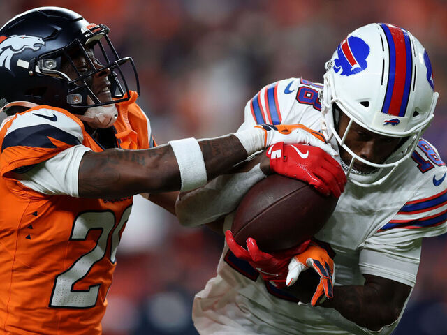 DENVER, COLORADO - JANUARY 17: Ja'quan McMillian #29 of the Denver Broncos intercepts a pass intended for Brandin Cooks #18 of the Buffalo Bills during overtime in the AFC Divisional Playoff game at Empower Field At Mile High on January 17, 2026 in Denver, Colorado.