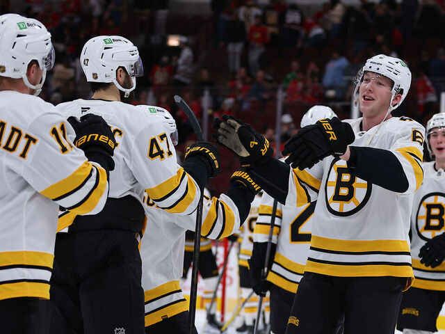 CHICAGO, IL - JANUARY 17: Mason Lohrei #6 of the Boston Bruins celebrates with teammates after a game against the Chicago Blackhawks on January 17, 2026 at the United Center in Chicago, Illinois.