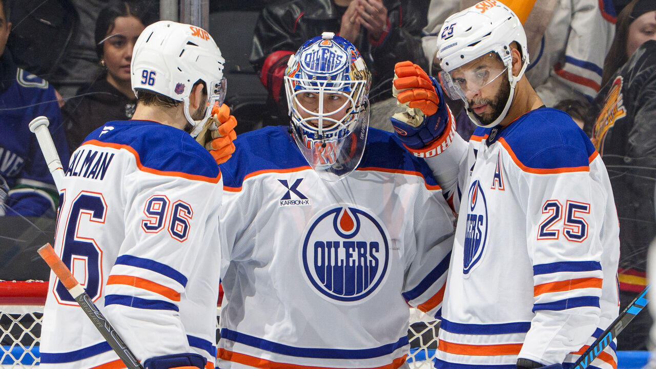 VANCOUVER, CANADA - JANUARY 17: Tristan Jarry #35 celebrates with Darnell Nurse #25 and Jake Walman #96 of the Edmonton Oilers after their NHL game against the Vancouver Canucks at Rogers Arena on January 17, 2026 in Vancouver, British Columbia, Canada. Oilers won 6-0.