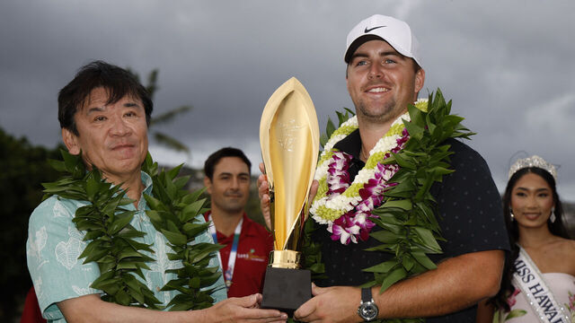 HONOLULU, HAWAII - JANUARY 18: Chris Gotterup of the United States is presented with the trophy on the 18th green after his winning round during the final round of the Sony Open in Hawaii 2026 at Waialae Country Club on January 18, 2026 in Honolulu, Hawaii.