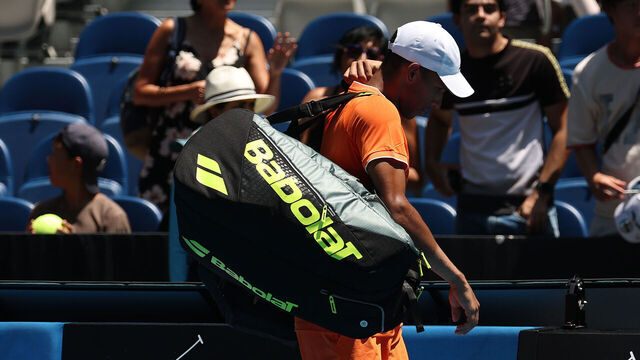 MELBOURNE, AUSTRALIA - JANUARY 19: Felix Auger-Aliassime of Canada leaves the court after retired in the Men's Singles First Round against Nuno Borges of Portugal during day two of the 2026 Australian Open at Melbourne Park on January 19, 2026 in Melbourne, Australia.