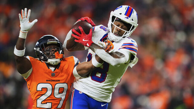 DENVER, CO - JANUARY 17: Ja'Quan McMillian #29 of the Denver Broncos fights for the ball with Brandin Cooks #18 of the Buffalo Bills during overtime of an AFC Divisional Playoff game at Empower Field At Mile High on January 17, 2026 in Denver, Colorado.