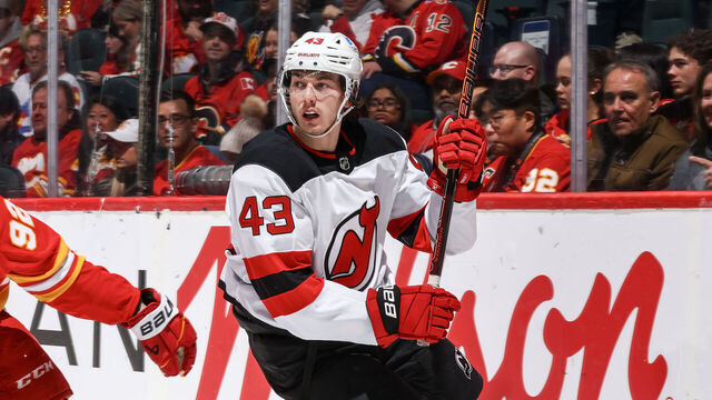CALGARY, AB - JANUARY 19: Matvei Gridin #92 of the Calgary Flames skates against Luke Hughes #43 of the New Jersey Devils at Scotiabank Saddledome on January 19, 2026 in Calgary, Alberta, Canada.