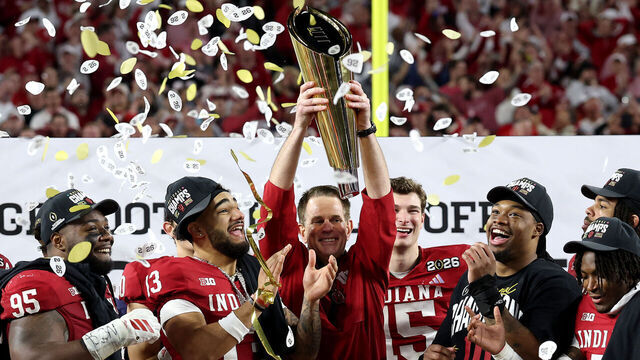 MIAMI GARDENS, FLORIDA - JANUARY 19: Head coach Curt Cignetti of the Indiana Hoosiers hoists the College Football Playoff National Championship Trophy after defeating the Miami Hurricanes 27-21 in the 2026 College Football Playoff National Championship at Hard Rock Stadium on January 19, 2026 in Miami Gardens, Florida.
