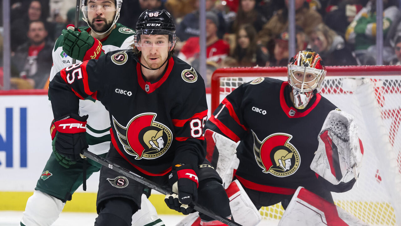 OTTAWA, ON - FEBRUARY 01: Ottawa Senators Defenceman Jake Sanderson (85) battles Minnesota Wild Center Devin Shore (19) in front of Ottawa Senators Goalie Leevi Merilainen (1) during second period National Hockey League action between the Minnesota Wild and Ottawa Senators on February 1, 2025, at Canadian Tire Centre in Ottawa, ON, Canada.