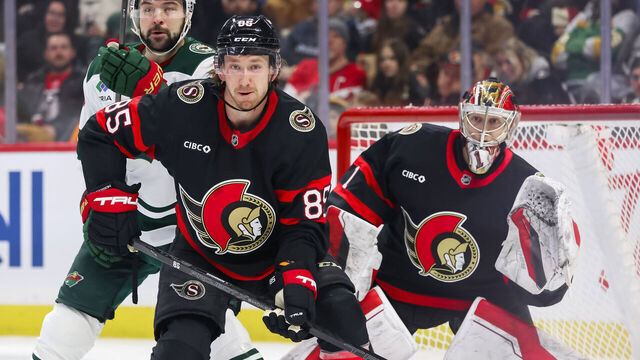 OTTAWA, ON - FEBRUARY 01: Ottawa Senators Defenceman Jake Sanderson (85) battles Minnesota Wild Center Devin Shore (19) in front of Ottawa Senators Goalie Leevi Merilainen (1) during second period National Hockey League action between the Minnesota Wild and Ottawa Senators on February 1, 2025, at Canadian Tire Centre in Ottawa, ON, Canada.