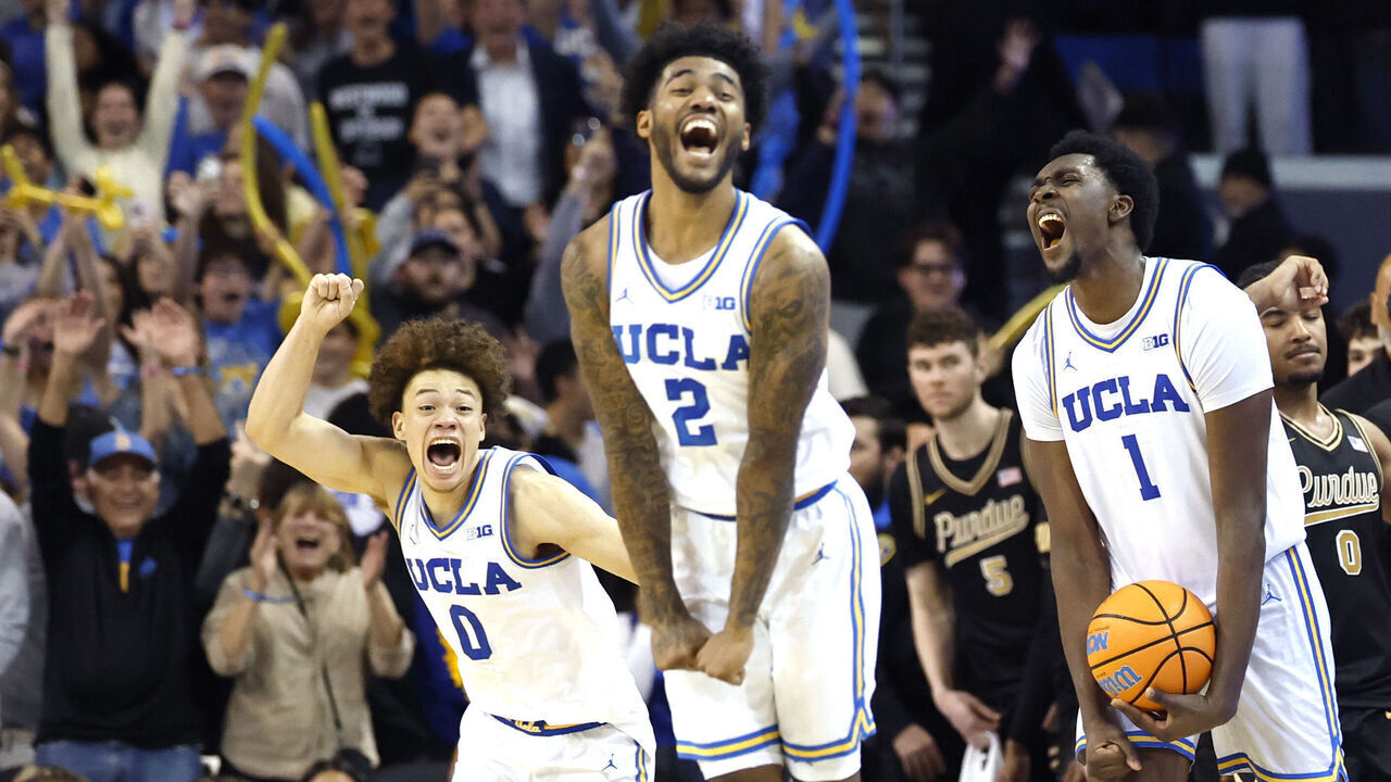 LOS ANGELES, CALIFORNIA - JANUARY 20: Xavier Booker #1, Trent Perry #0 and Donovan Dent #2 of the UCLA Bruins celebrate a 69-67 win over the Purdue Boilermakers at UCLA Pauley Pavilion on January 20, 2026 in Los Angeles, California.