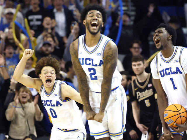 LOS ANGELES, CALIFORNIA - JANUARY 20: Xavier Booker #1, Trent Perry #0 and Donovan Dent #2 of the UCLA Bruins celebrate a 69-67 win over the Purdue Boilermakers at UCLA Pauley Pavilion on January 20, 2026 in Los Angeles, California.