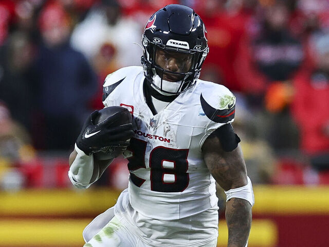 KANSAS CITY, MISSOURI - JANUARY 18: Joe Mixon #28 of the Houston Texans carries the ball on a running play during the second half of the AFC Divisional playoff game against the Kansas City Chiefs at GEHA Field at Arrowhead Stadium on January 18, 2025 in Kansas City, Missouri.