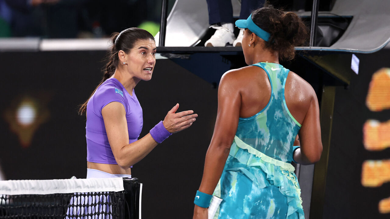 Romania's Sorana Cirstea talks with Japan's Naomi Osaka (R) following their second-round match on day five of the Australian Open tennis tournament in Melbourne on January 22, 2026. / -- IMAGE RESTRICTED TO EDITORIAL USE - STRICTLY NO COMMERCIAL USE --