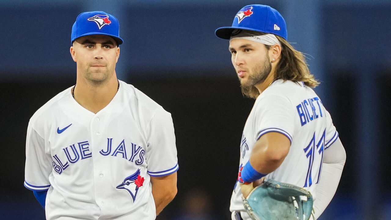 TORONTO, ON - AUGUST 12: (L-R) Matt Chapman #26, Whit Merrifield #1 and Bo Bichette #11 of the Toronto Blue Jays look on during a break in play against the Cleveland Guardians in the eighth inning of their MLB game at the Rogers Centre on August 12, 2022 in Toronto, Ontario, Canada.