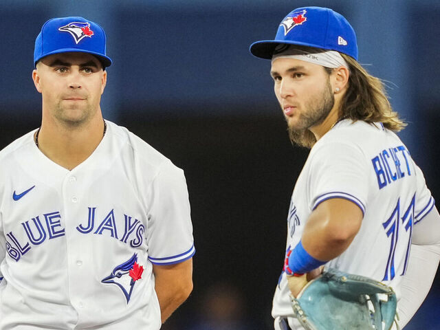 TORONTO, ON - AUGUST 12: (L-R) Matt Chapman #26, Whit Merrifield #1 and Bo Bichette #11 of the Toronto Blue Jays look on during a break in play against the Cleveland Guardians in the eighth inning of their MLB game at the Rogers Centre on August 12, 2022 in Toronto, Ontario, Canada.