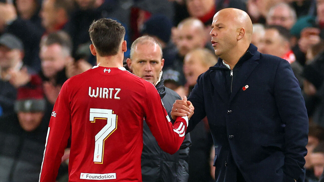 LIVERPOOL, ENGLAND - NOVEMBER 04: Florian Wirtz of Liverpool shakes hands with coach Arne Slot as he leaves the field after being substituted during the UEFA Champions League 2025/26 League Phase MD4 match between Liverpool FC and Real Madrid C.F. at Anfield on November 04, 2025 in Liverpool, England.