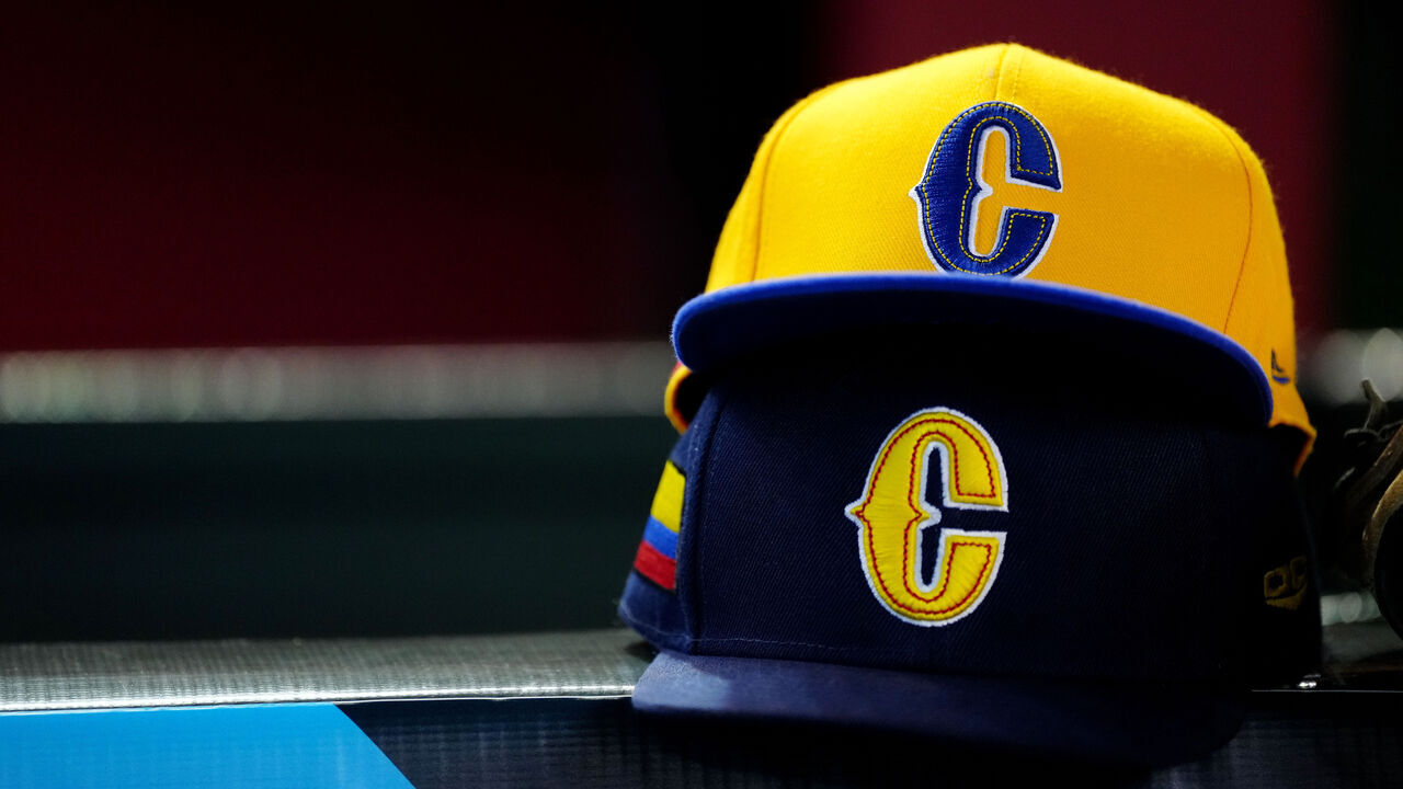PHOENIX, AZ - MARCH 13: A detail shot of the Team Colombia hats on the bench prior to Game 5 of Pool C between Team Colombia and Team Great Britain at Chase Field on Monday, March 13, 2023 in Phoenix, Arizona.