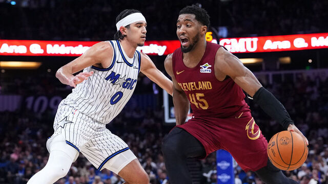 ORLANDO, FLORIDA - JANUARY 24: Donovan Mitchell #45 of the Cleveland Cavaliers dribbles the ball against Anthony Black #0 of the Orlando Magic during the third quarter at Kia Center on January 24, 2026 in Orlando, Florida.