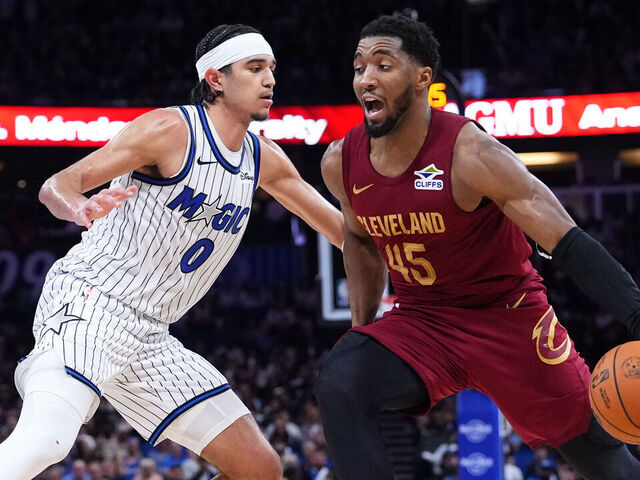 ORLANDO, FLORIDA - JANUARY 24: Donovan Mitchell #45 of the Cleveland Cavaliers dribbles the ball against Anthony Black #0 of the Orlando Magic during the third quarter at Kia Center on January 24, 2026 in Orlando, Florida.