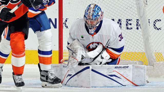 PHILADELPHIA, PENNSYLVANIA - JANUARY 26: Noah Cates #27 of the Philadelphia Flyers battles for position with Scott Mayfield #24 of the New York Islanders in front of goaltender Ilya Sorokin #30 at the Xfinity Mobile Arena on January 26, 2026 in Philadelphia, Pennsylvania.