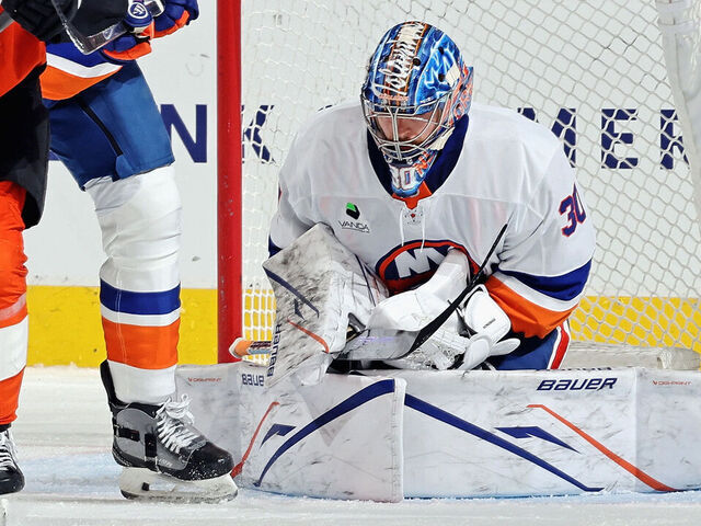PHILADELPHIA, PENNSYLVANIA - JANUARY 26: Noah Cates #27 of the Philadelphia Flyers battles for position with Scott Mayfield #24 of the New York Islanders in front of goaltender Ilya Sorokin #30 at the Xfinity Mobile Arena on January 26, 2026 in Philadelphia, Pennsylvania.