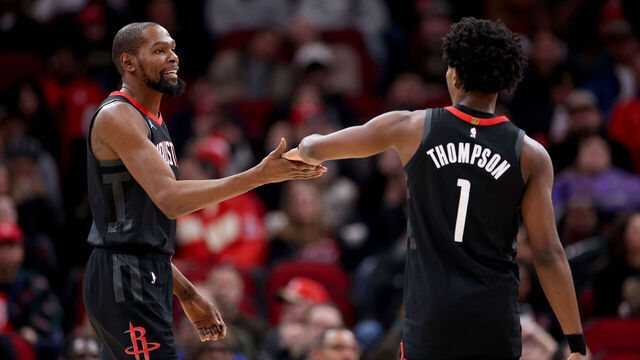 HOUSTON, TEXAS - JANUARY 26: Kevin Durant #7 of the Houston Rockets congratulates Amen Thompson #1 in the first half against the Memphis Grizzlies at Toyota Center on January 26, 2026 in Houston, Texas.