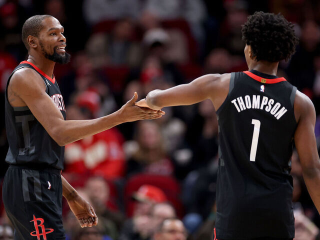 HOUSTON, TEXAS - JANUARY 26: Kevin Durant #7 of the Houston Rockets congratulates Amen Thompson #1 in the first half against the Memphis Grizzlies at Toyota Center on January 26, 2026 in Houston, Texas.