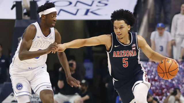 PROVO, UT - JANUARY 26: Brayden Burries #5 of the Arizona Wildcats brings the ball up court against AJ Dybantsa #3 of the Brigham Young Cougars in the first half at the Marriott Center on January 26, 2026 in Provo, Utah.