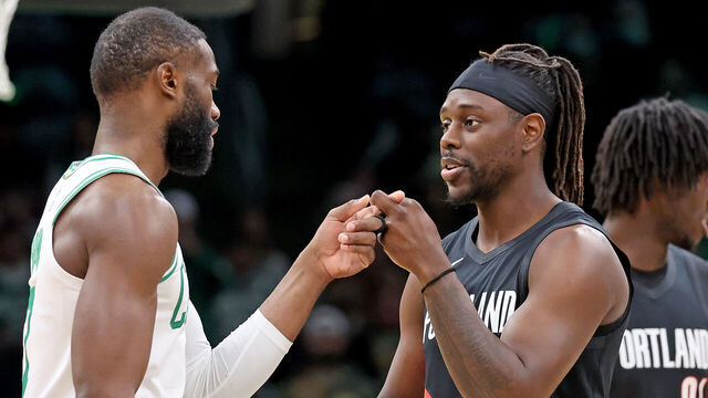 Boston, MA - January 26 - Boston Celtics guard Jaylen Brown (7) and Portland Trail Blazers guard Jrue Holiday (5) meet up before the NBA game at the Garden. .