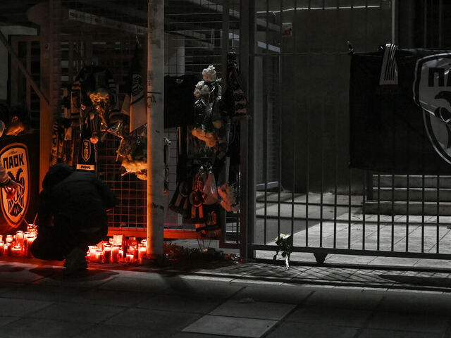 Mourners light candles outside of the Toumba stadium, also known as the PAOK stadium, in Thessaloniki on January 27, 2026, following the fatal collision of a minibus transporting PAOK Thessaloniki football club supporters with a truck in Romania. A minibus transporting Greek football fans collided with a truck in Romania on January 27, 2026, leaving seven dead and three injured, officials said. The minibus carrying 10 men was travelling from Greece to France where the fans were planning to attend the Europa League match between PAOK and Lyon on January 29, 2026, when it collided with a truck in Timis county in western Romania, local police said.