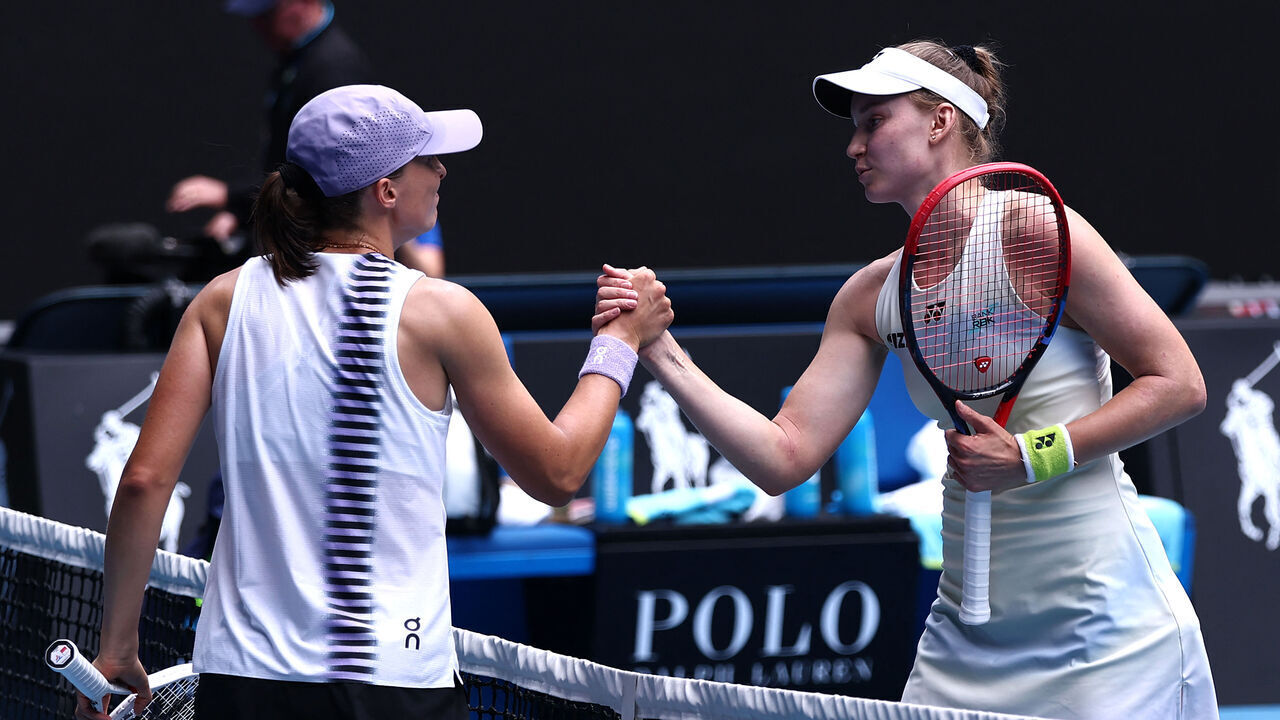 Kazakhstan's Elena Rybakina (R) shakes hands with Poland's Iga Swiatek after their women's singles quarter-final match on day eleven of the Australian Open tennis tournament in Melbourne on January 28, 2026. / -- IMAGE RESTRICTED TO EDITORIAL USE - STRICTLY NO COMMERCIAL USE --