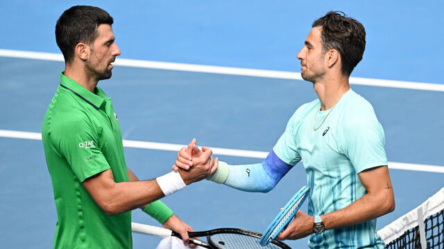 MELBOURNE, AUSTRALIA - JANUARY 28: Lorenzo Musetti (R) of Italy greets Novak Djokovic of Serbia after Musetti retired due to injury in the Men's Singles Quarter Finals match during day eleven of the 2026 Australian Open at Melbourne Park on January 28, 2026 in Melbourne, Australia.