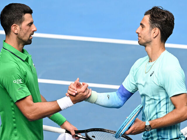 MELBOURNE, AUSTRALIA - JANUARY 28: Lorenzo Musetti (R) of Italy greets Novak Djokovic of Serbia after Musetti retired due to injury in the Men's Singles Quarter Finals match during day eleven of the 2026 Australian Open at Melbourne Park on January 28, 2026 in Melbourne, Australia.