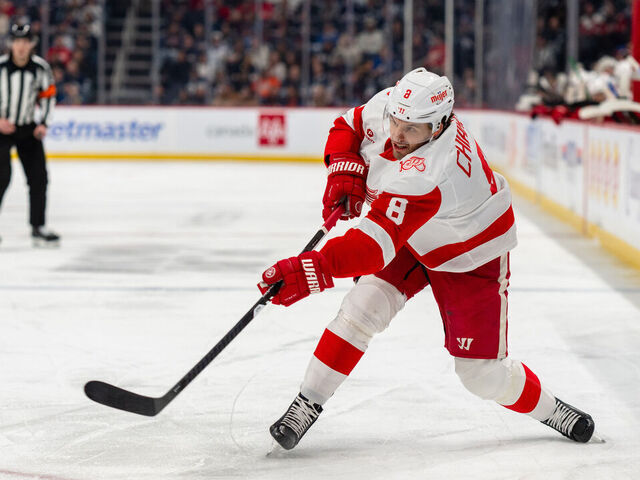 WINNIPEG, CANADA - JANUARY 24: Ben Chiarot #8 of the Detroit Red Wings shoots the puck in the first period against the Winnipeg Jets at Canada Life Centre on January 24, 2026 in Winnipeg, Canada.