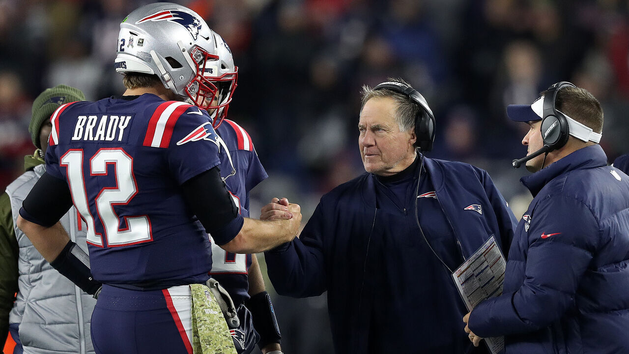 FOXBOROUGH, MA - NOVEMBER 4: New England Patriots quarterback Tom Brady (12) gets a hand from head coach Bill Belichick as the clock was running down in the New England victory over the Packers. Offensive coordinator Josh McDaniels is at far right. The New England Patriots host the Green Bay Packers in a regular season NFL football game at Gillette Stadium in Foxborough, MA on Nov. 4, 2018.