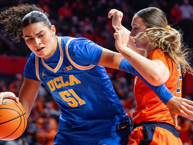 CHAMPAIGN, ILLINOIS - JANUARY 28: Lauren Betts #51 of the UCLA Bruins goes to the basket against Hayven Smith #25 of the Illinois Fighting Illini during the second half at State Farm Center on January 28, 2026 in Champaign, Illinois.