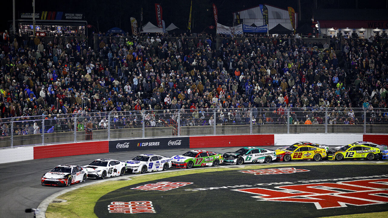 WINSTON SALEM, NORTH CAROLINA - FEBRUARY 02: Denny Hamlin, driver of the #11 Sport Clips Haircuts Toyota, Tyler Reddick, driver of the #45 Jordan Brand Toyota and Chase Elliott, driver of the #9 NAPA Auto Parts Chevrolet race during the Cook Out Clash at Bowman Gray Stadium on February 02, 2025 in Winston Salem, North Carolina.