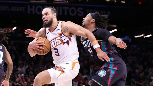 PHOENIX, ARIZONA - JANUARY 29: Dillon Brooks #3 of the Phoenix Suns dribbles the ball past Ronald Holland II #5 of the Detroit Pistons during the second half at Mortgage Matchup Center on January 29, 2026 in Phoenix, Arizona.
