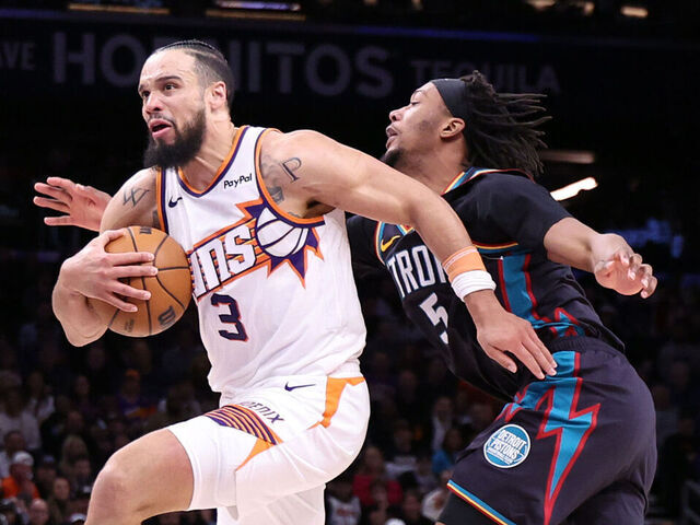 PHOENIX, ARIZONA - JANUARY 29: Dillon Brooks #3 of the Phoenix Suns dribbles the ball past Ronald Holland II #5 of the Detroit Pistons during the second half at Mortgage Matchup Center on January 29, 2026 in Phoenix, Arizona.