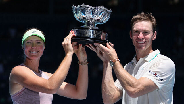 Australia's Olivia Gadecki and John Peers pose with the trophy after victory against France's Kristina Mladenovic and Manuel Guinard during their mixed doubles final match on day thirteen of the Australian Open tennis tournament in Melbourne on January 30, 2026. / -- IMAGE RESTRICTED TO EDITORIAL USE - STRICTLY NO COMMERCIAL USE --