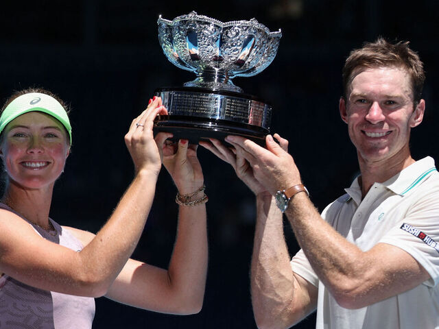 Australia's Olivia Gadecki and John Peers pose with the trophy after victory against France's Kristina Mladenovic and Manuel Guinard during their mixed doubles final match on day thirteen of the Australian Open tennis tournament in Melbourne on January 30, 2026. / -- IMAGE RESTRICTED TO EDITORIAL USE - STRICTLY NO COMMERCIAL USE --