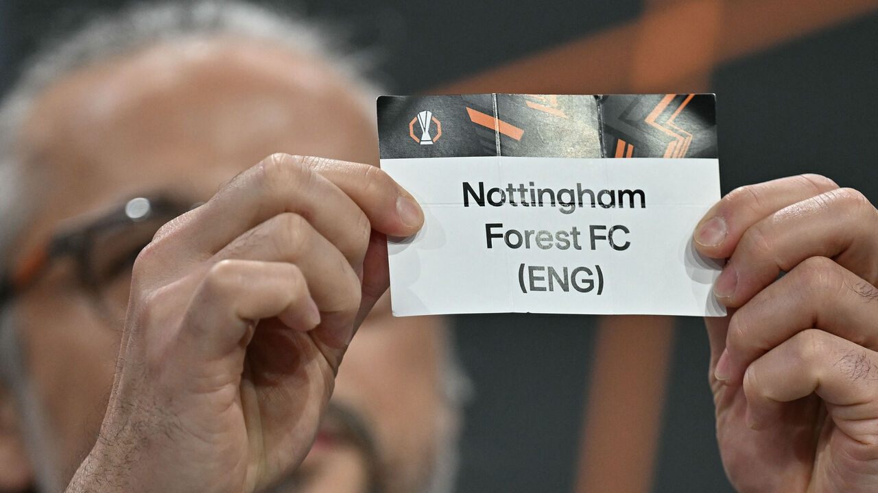 Turkish former football player and UEFA Europa League ambassador Ilhan Mansiz holds up the slip of Nottingham Forest (ENG) during the 2025-2026 UEFA Europa League knockout phase play-off draw at the House of European Football in Nyon on January 30, 2026. The draw involves the teams finishing in ninth to 24th place in the league phase the top eight sides in the league phase qualifying automatically for the round of 16.