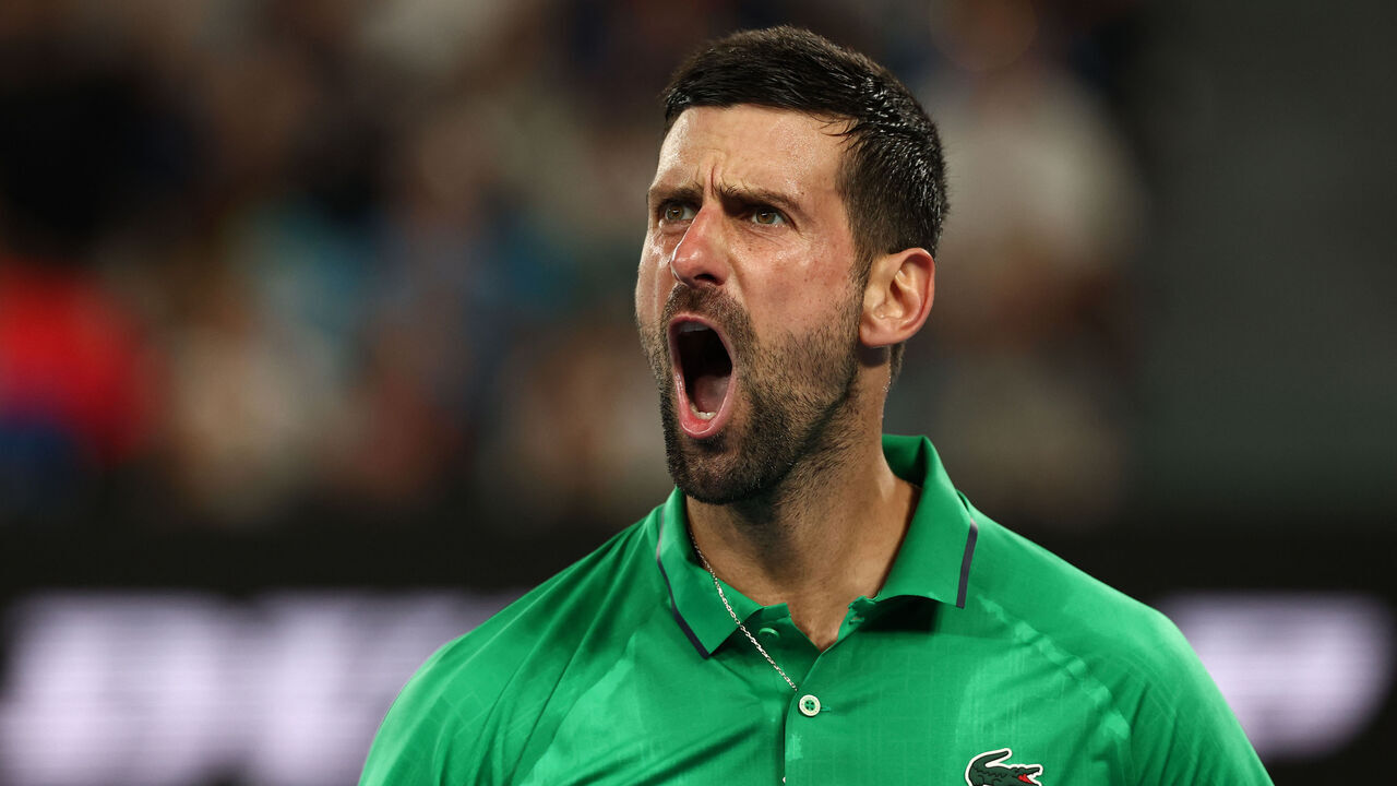 Serbia's Novak Djokovic reacts on a point to Italy's Jannik Sinner during their men's singles semi-final match on day thirteen of the Australian Open tennis tournament in Melbourne on January 31, 2026. / -- IMAGE RESTRICTED TO EDITORIAL USE - STRICTLY NO COMMERCIAL USE --