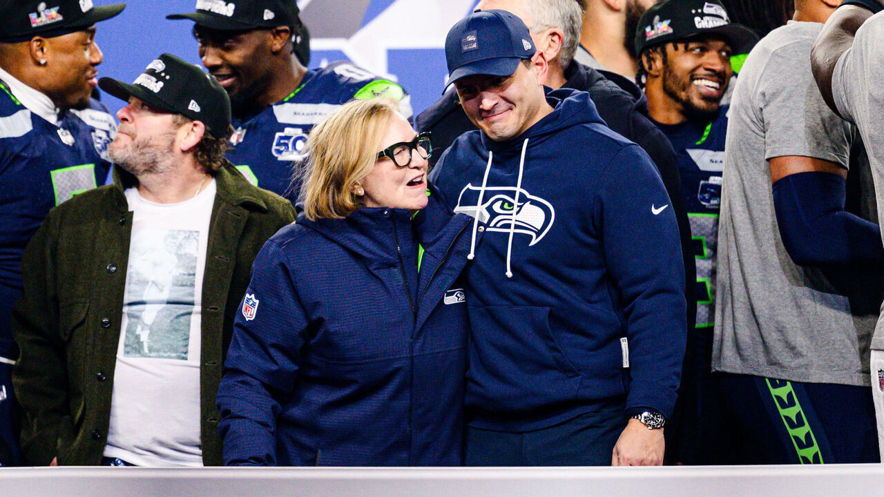 SEATTLE, WASHINGTON - JANUARY 25: Head coach Mike MacDonald celebrates with Jody Allen of the Seattle Seahawks during the George Halas trophy presentation after Seattle won the NFC Championship game against the Los Angeles Rams at Lumen Field on January 25, 2026 in Seattle, Washington.