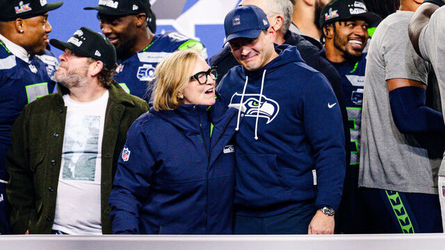 SEATTLE, WASHINGTON - JANUARY 25: Head coach Mike MacDonald celebrates with Jody Allen of the Seattle Seahawks during the George Halas trophy presentation after Seattle won the NFC Championship game against the Los Angeles Rams at Lumen Field on January 25, 2026 in Seattle, Washington.