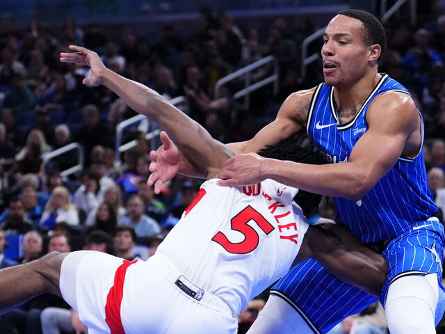 ORLANDO, FLORIDA - JANUARY 30: Desmond Bane #3 of the Orlando Magic fouls Immanuel Quickley #5 of the Toronto Raptors during the second quarter at Kia Center on January 30, 2026 in Orlando, Florida.