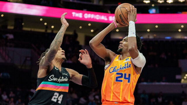CHARLOTTE, NORTH CAROLINA - JANUARY 31: Brandon Miller #24 of the Charlotte Hornets shoots the ball over Devin Vassell #24 of the San Antonio Spurs in the first half at Spectrum Center on January 31, 2026 in Charlotte, North Carolina.